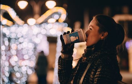 Christmas Market in Krakow- girl drinking mulled wine on the Christmas Market.