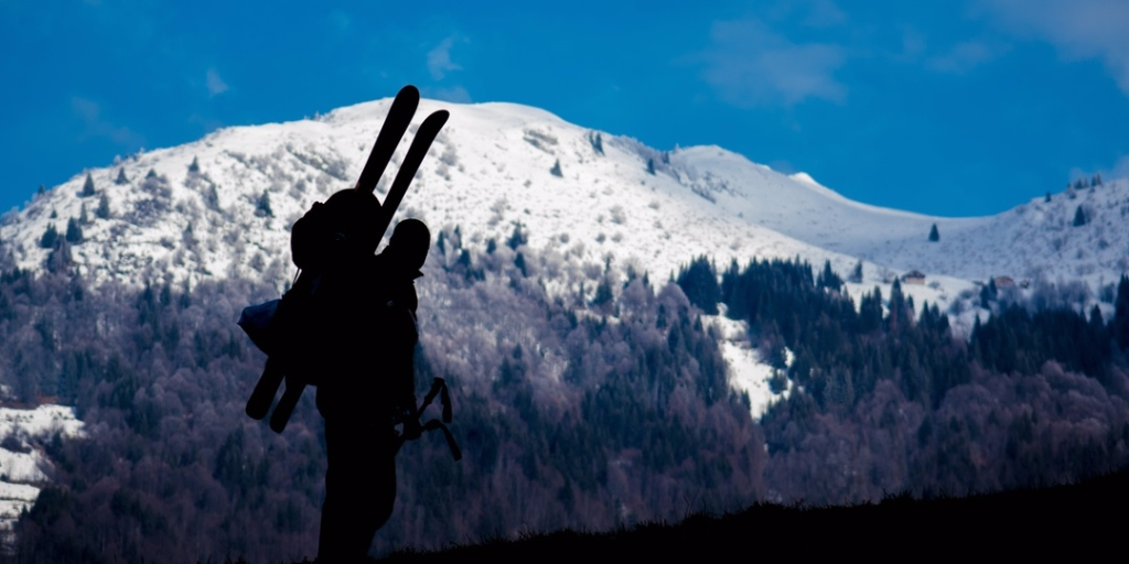 Visit Krakow to become skier standing in front of white mountain. 