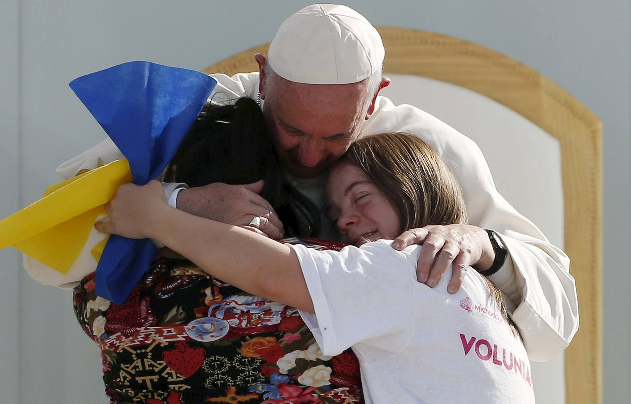 Pope Francis hugging two girls during Youth Days in Krakow. 