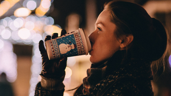 Christmas Market in Krakow- girl drinking mulled wine on the Christmas Market.